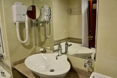 a bathroom with a sink and a mirror at Elinor Apartment - Downtown in Bansko
