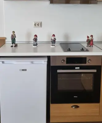 a kitchen with figurines on a counter and a stove at Pirin Golf Private Apartments & Studios in Razlog