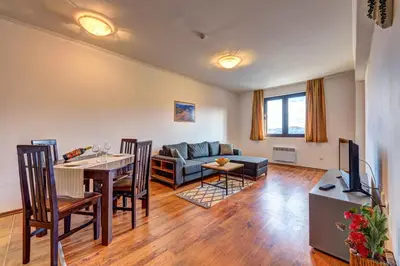 a living room with a couch and a table with a dining room at Complex Silver Hills in Smolyan
