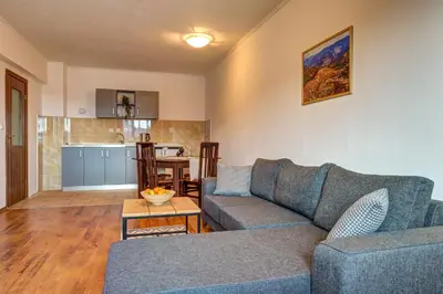 a living room with a couch and a table at Complex Silver Hills in Smolyan