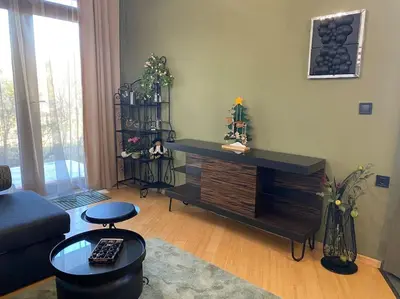 a living room with a couch and a table at Cozy mountain apartament near the Gondola lift in Bansko