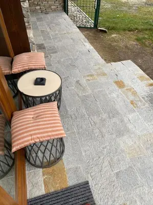 a patio with two stools and a table on a patio at Cozy mountain apartament near the Gondola lift in Bansko
