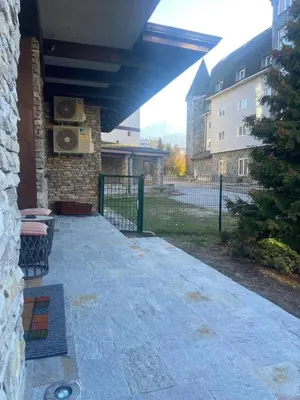 a patio with a bench next to a building at Cozy mountain apartament near the Gondola lift in Bansko