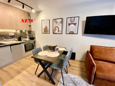 a kitchen and dining room with a table and chairs at Antonovi Apartments 1 in hotel Laplandia in Pamporovo