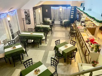 an overhead view of a restaurant with green tables and chairs at Antonovi Apartments 1 in hotel Laplandia in Pamporovo