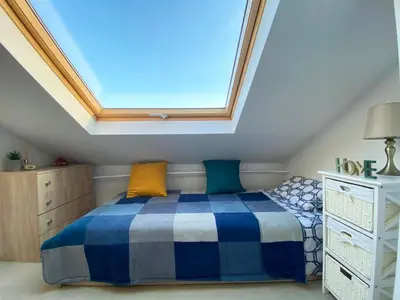 a bedroom with a bed and a skylight at LK17 - Loft in the Center in Sofia