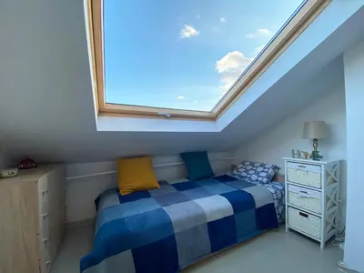 a bedroom with a bed with a skylight at LK17 - Loft in the Center in Sofia