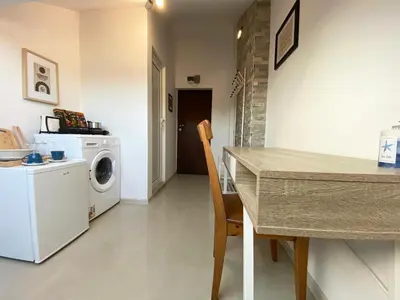 a kitchen with a table and a washing machine at LK17 - Loft in the Center in Sofia
