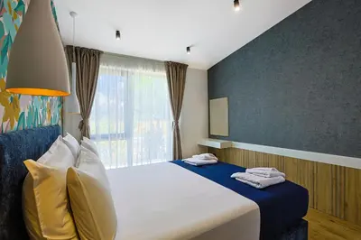 a bedroom with a large bed with a window at Terme di Hissar Village in Hisarya