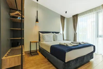 a bedroom with a bed and a large window at Terme di Hissar Village in Hisarya