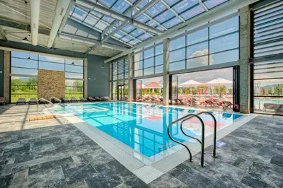 a large swimming pool with a large glass ceiling at Terme di Hissar Village in Hisarya