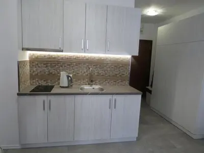 a kitchen with white cabinets and a sink at Flora Clover One Bedroom Apartment nr. 18 in Borovets