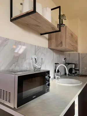 a kitchen with a microwave and a sink at Altavista mountain apartment in Samokov