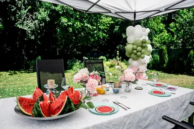 a table with a plate of watermelons on it at Къща за гости ЗЕЛЕНА in Vinogradets