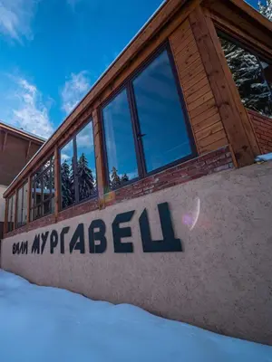 a building with a sign on the side of it at Boutique Villas Murgavets Pamporovo in Pamporovo