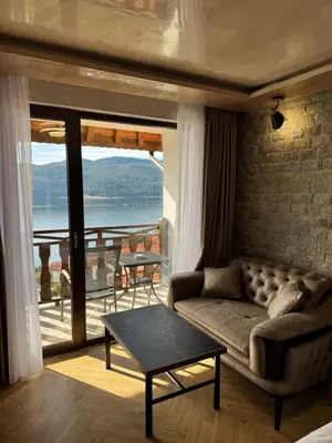 a living room with a couch and a table at OASIS RESORT RHODOPES in Dospat