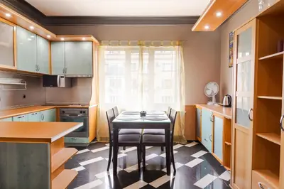 a small kitchen with a table and chairs in it at Your home away from home in Sofia