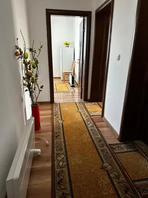 a hallway with a door and a vase of flowers at Snow House in Bansko