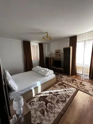 a hotel room with a bed and a rug at Snow House in Bansko