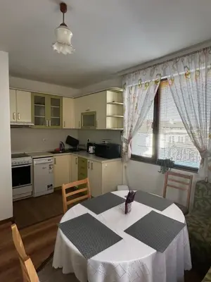 a kitchen with a table with a white table cloth on it at Snow House in Bansko