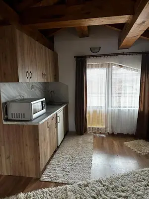 a kitchen with a microwave on a counter with a window at Snow House in Bansko