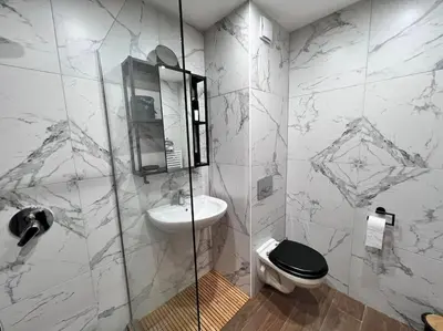 a bathroom with a toilet and a sink at Апартамент - Боровец Хотел ''Боровец Гардънс'' A 44 in Borovets