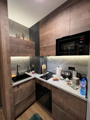 a kitchen with a sink and a microwave at Апартамент - Боровец Хотел ''Боровец Гардънс'' A 44 in Borovets