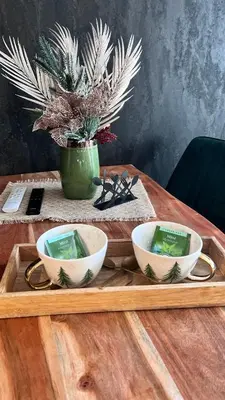 a wooden tray with three bowls on a table at Апартамент - Боровец Хотел ''Боровец Гардънс'' A 44 in Borovets