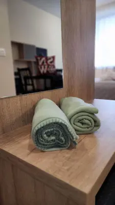 two pillows sitting on a wooden counter in front of a mirror at Arboro Borovets Gardens E50 in Borovets