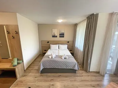 a bedroom with a bed with two stuffed animals on it at Arboro Borovets Gardens E50 in Borovets