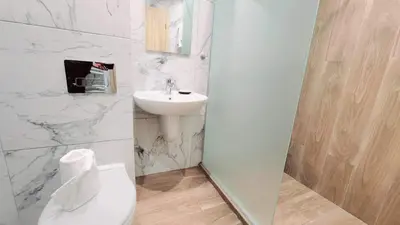 a white bathroom with a sink and a toilet at Arboro Borovets Gardens E68 in Borovets