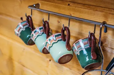 a group of coffee mugs hanging on a wall at Sofia Folklore Life Apartment in Sofia