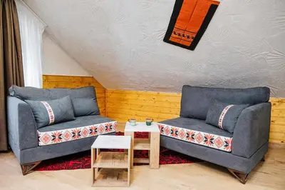 a living room with two blue couches and a table at Sofia Folklore Life Apartment in Sofia