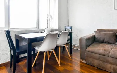 a dining room with a table and chairs and a couch at Budget Stay in City Center near NDK in Sofia
