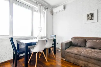 a living room with a table and chairs and a couch at Budget Stay in City Center near NDK in Sofia