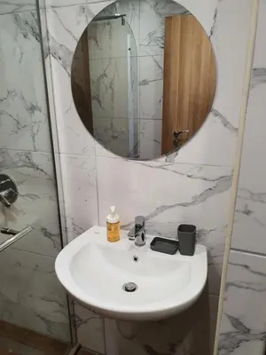 a bathroom with a white sink and a mirror at Апартамент B9 in Borovets