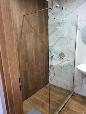 a shower with a glass door in a bathroom at Апартамент B9 in Borovets