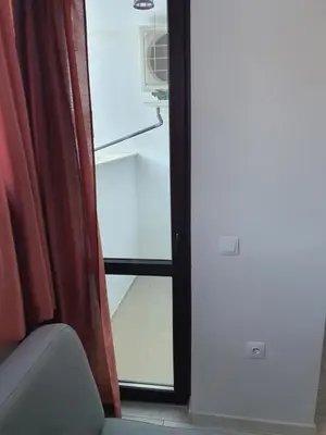 a room with a door with a window and a chair at Апартамент B9 in Borovets