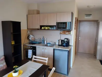 a small kitchen with a table and a counter top at Студио Пацо и Нина в AspenValley in Razlog