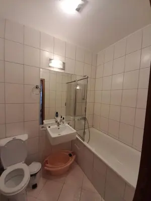 a bathroom with a toilet and a sink and a tub at SNOW PEAK TODORKA APARTAMENT /NEXT TO THE LIFT/ 6 PERSONS in Bansko