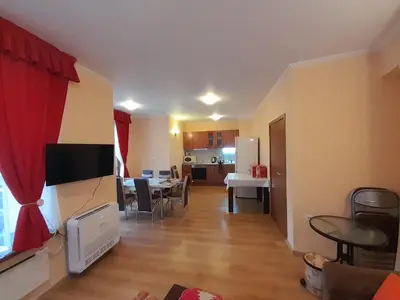 a living room with a kitchen and a dining room at SNOW PEAK TODORKA APARTAMENT /NEXT TO THE LIFT/ 6 PERSONS in Bansko