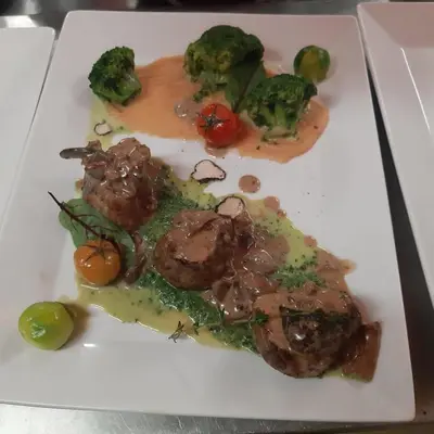 a plate of food with meat and vegetables on it at SNOW PEAK TODORKA APARTAMENT /NEXT TO THE LIFT/ 6 PERSONS in Bansko