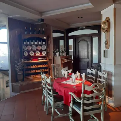 a dining room with a red table and chairs at SNOW PEAK TODORKA APARTAMENT /NEXT TO THE LIFT/ 6 PERSONS in Bansko