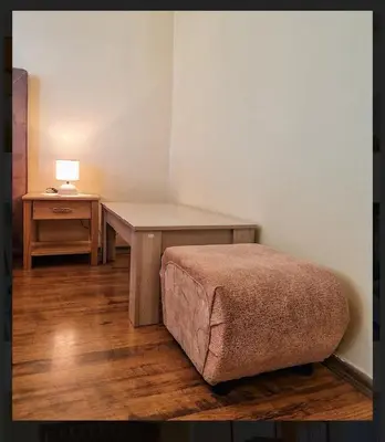a room with a desk and a bed and a table at Къща за гости Карасански in Bansko
