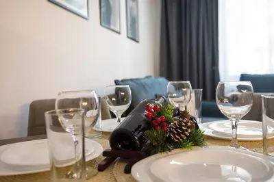 a table with wine glasses and christmas decorations on it at Antonovi Apartments 2 in hotel Laplandia in Pamporovo