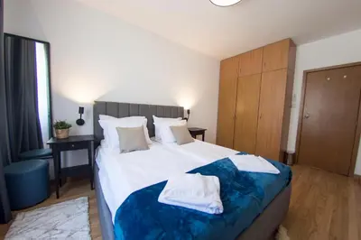 a bedroom with a large bed with towels on it at Antonovi Apartments 2 in hotel Laplandia in Pamporovo