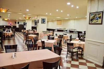 a dining room with tables and chairs in a restaurant at Sana Ski apartment 620 in Flora, Borovets in Borovets