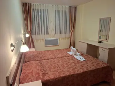 a hotel room with a bed with a stuffed animal on it at Ski Area @ Apartment Rosea 205 @ Pamporovo in Pamporovo