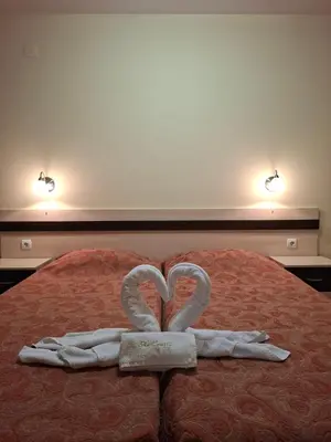 two towels in the shape of a heart on a bed at Ski Area @ Apartment Rosea 205 @ Pamporovo in Pamporovo