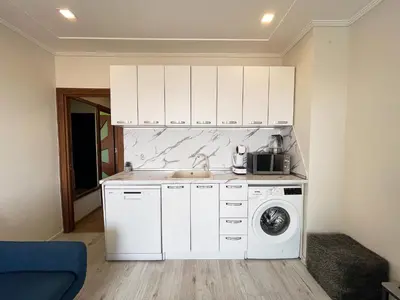 a kitchen with a sink and a washing machine at Amazing view central 1 bedroom apartment in Pazardzhik